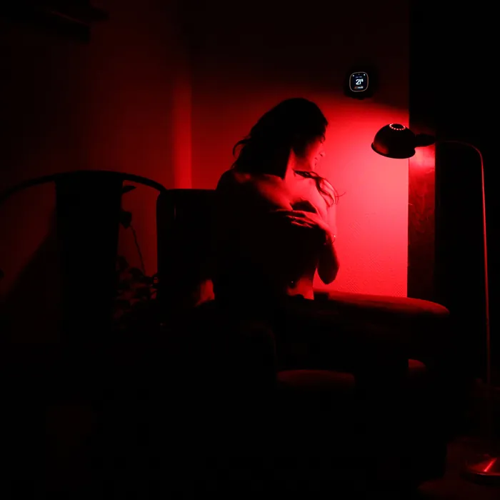 Figure silhouetted in a red-lit room