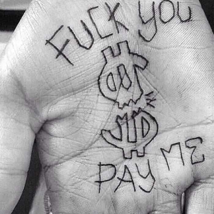 Palm drawn over with dollar signs and handwritten words
