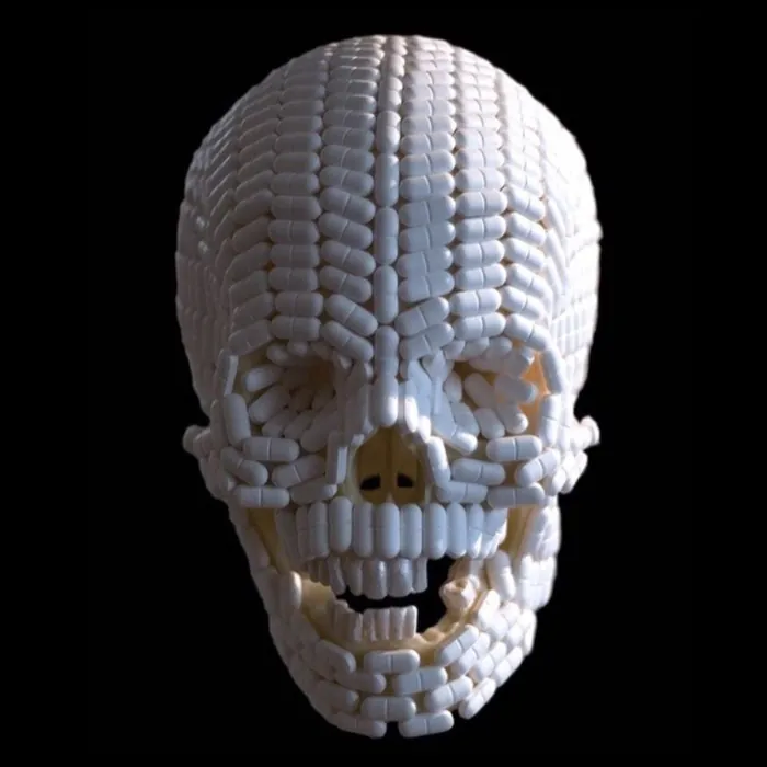 Skull built from white pills on black