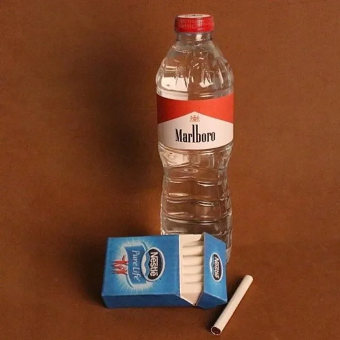 Water bottle and cigarette pack on a brown table