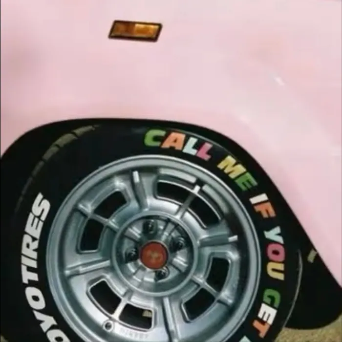Pink car with a lettered white tyre