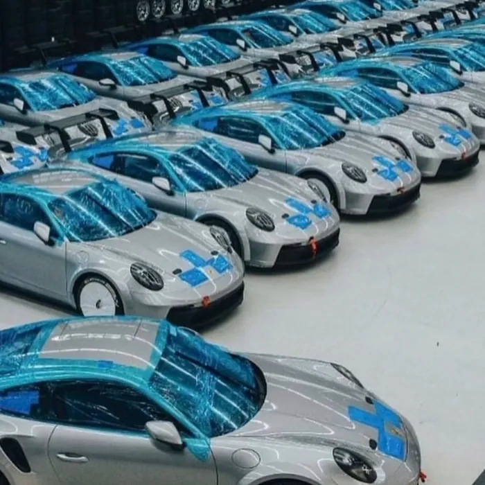 Rows of white and blue sports cars in a lot